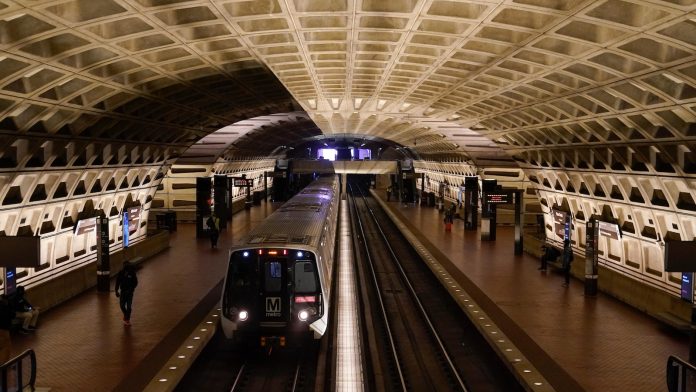 A work vehicle hits a stopped Washington Metro train, injuring 11